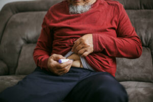 man Injecting sermorlin in his home