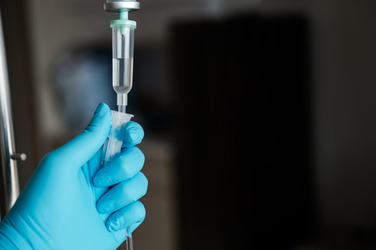 Hand holding IV drip equipment