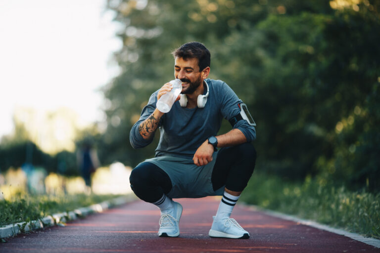 Man drinking water after exercise