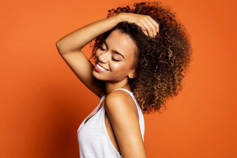 Smiling woman with curly hair after botox treatment
