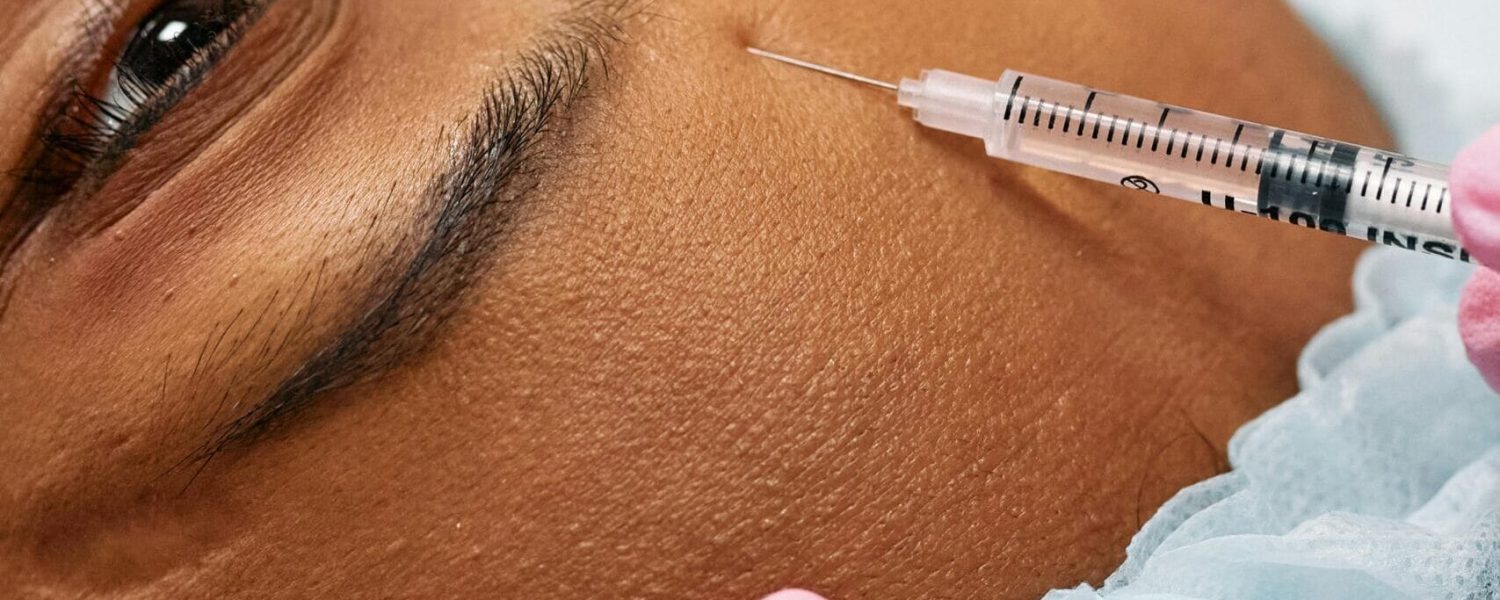 a person getting a Botox injection in their face